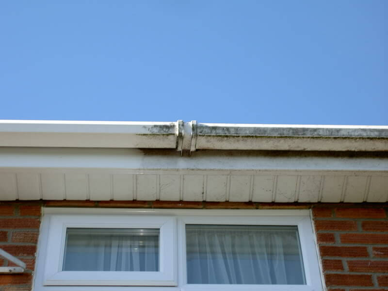 image of a plastic gutter getting restored and cleaned back to white