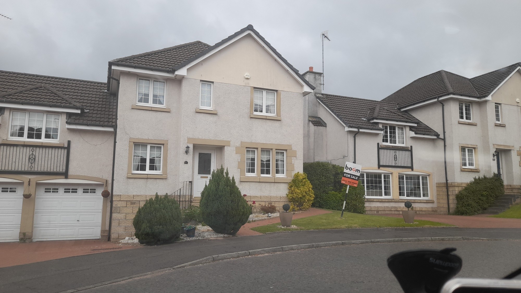 image of a large house getting a small roof repair in Renfrewshire